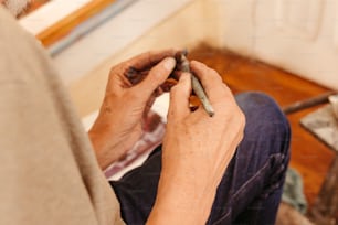 a person sitting on a couch holding a cigarette