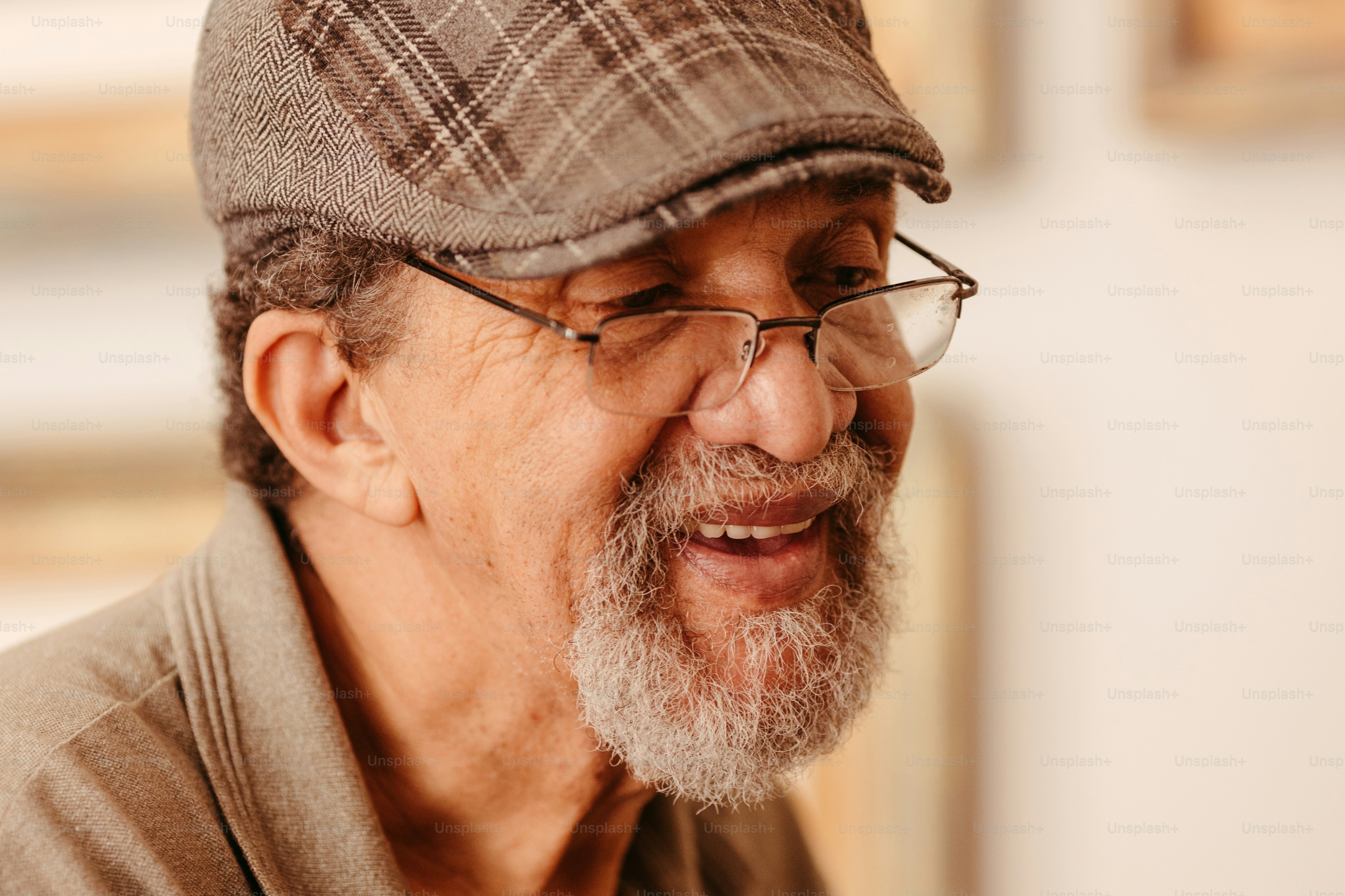 a close up of a person wearing glasses and a hat