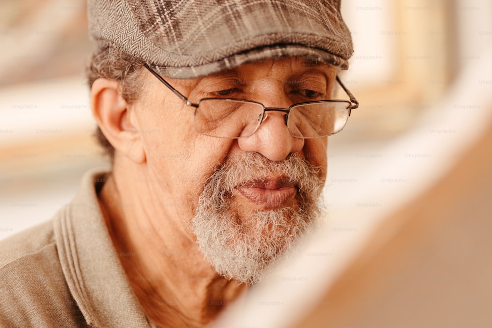an older man wearing glasses and a hat