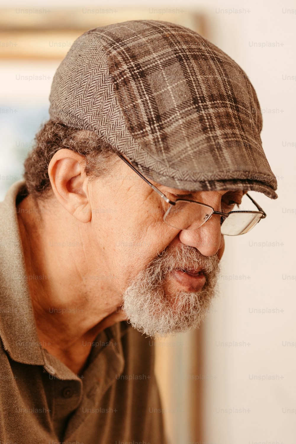 a man with a beard wearing a hat and glasses