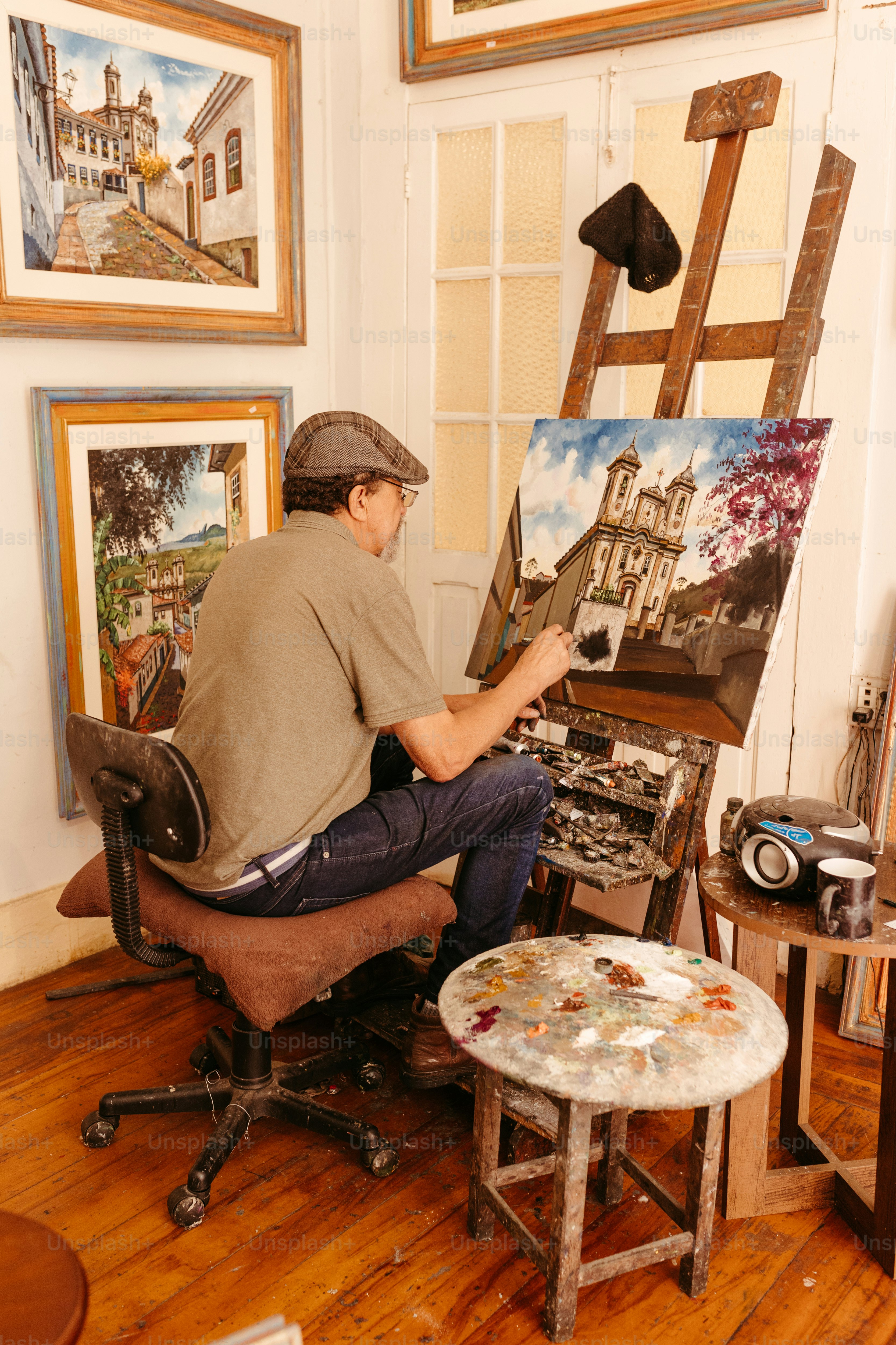 a man sitting on a chair in front of a painting