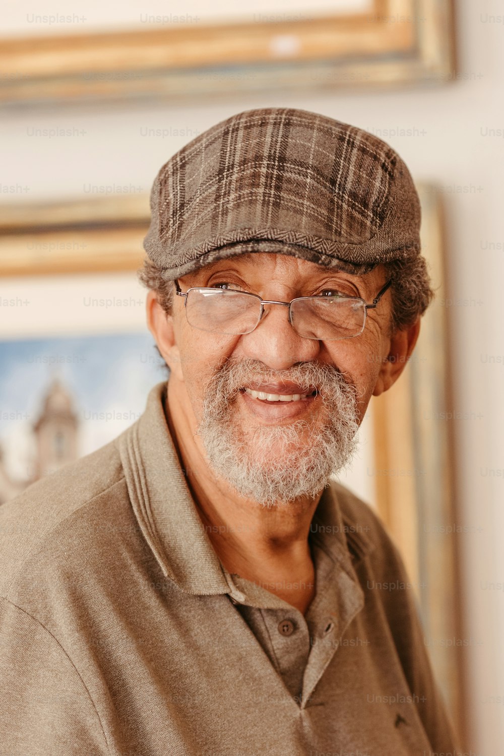 a man with glasses and a hat smiling