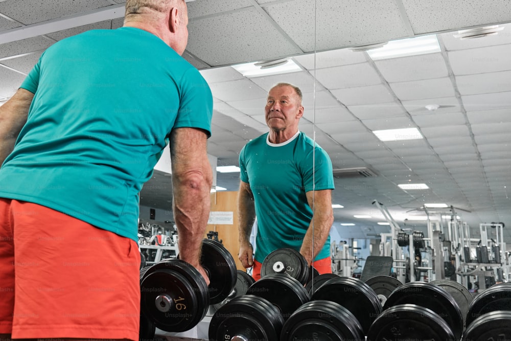 a couple of men standing next to each other in a gym