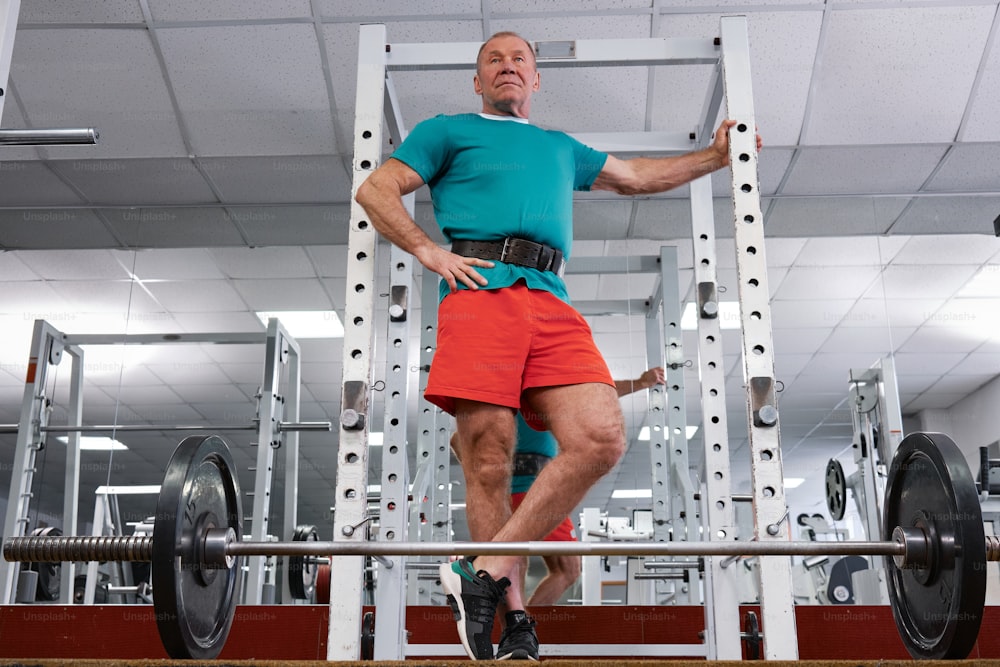 a man standing on a bench in a gym