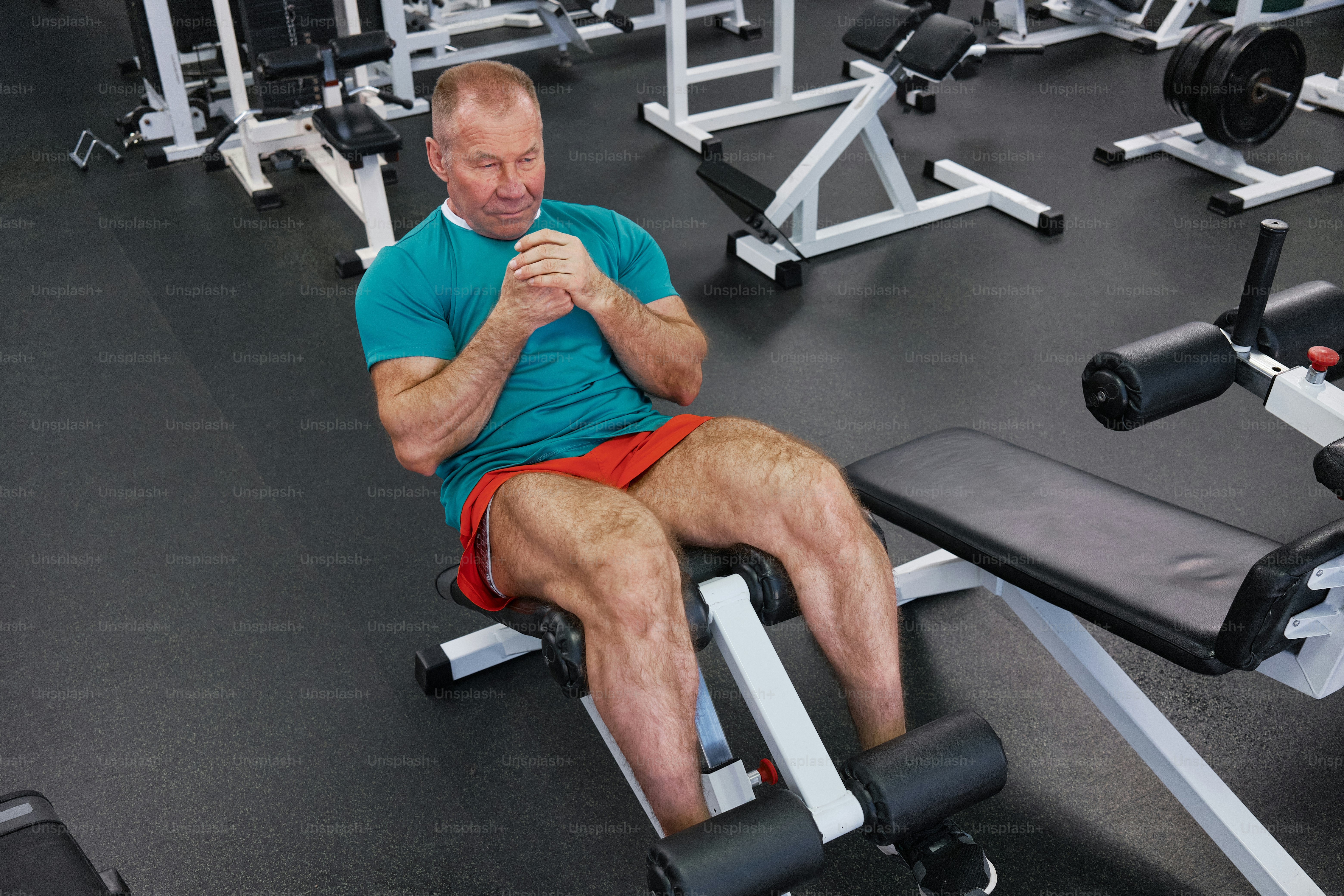 A male pensioner doing abs at the gym