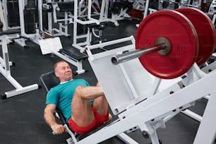 a man laying on a bench in a gym