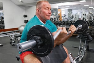 a man lifting a barbell in a gym