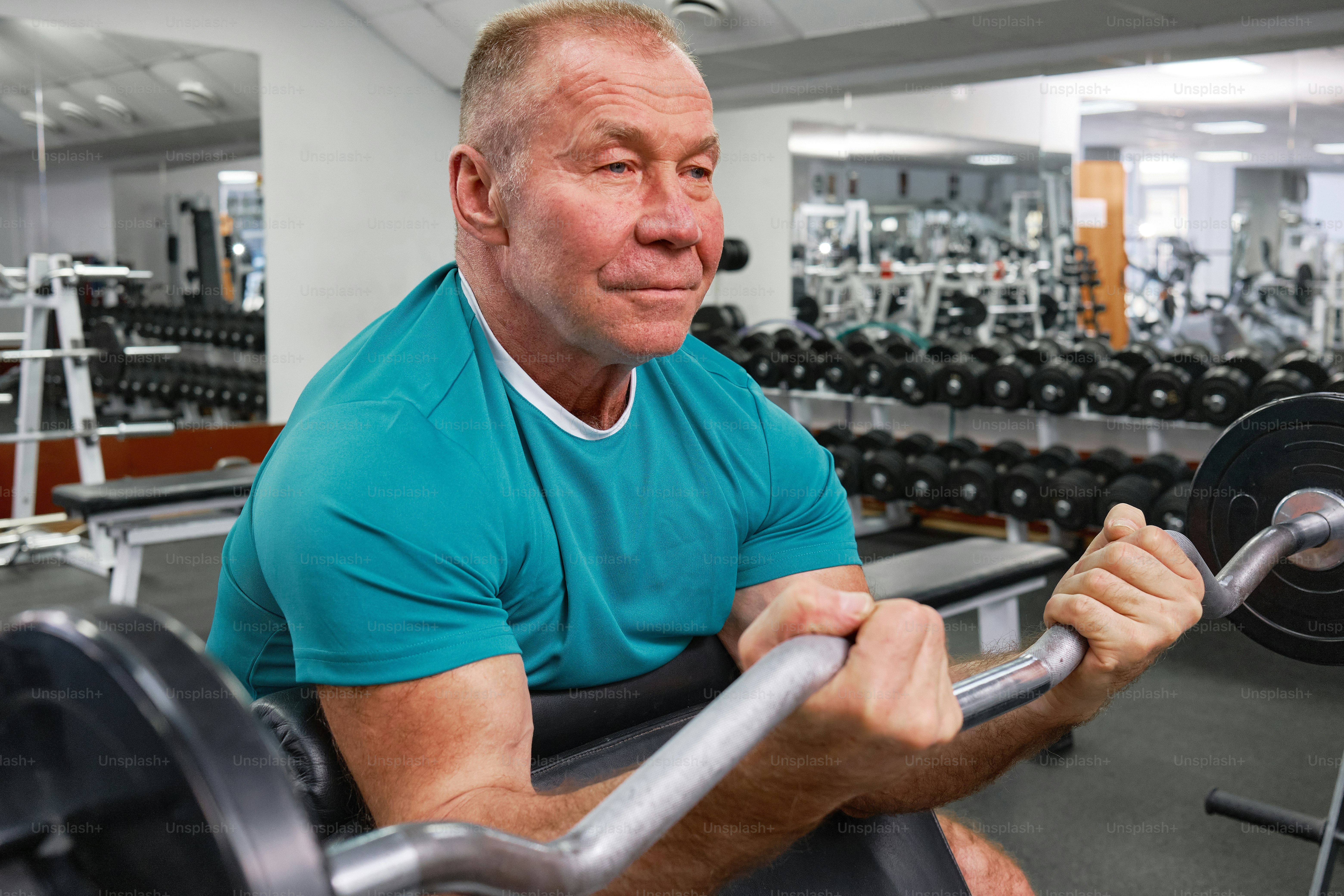 a man in a gym with a barbell