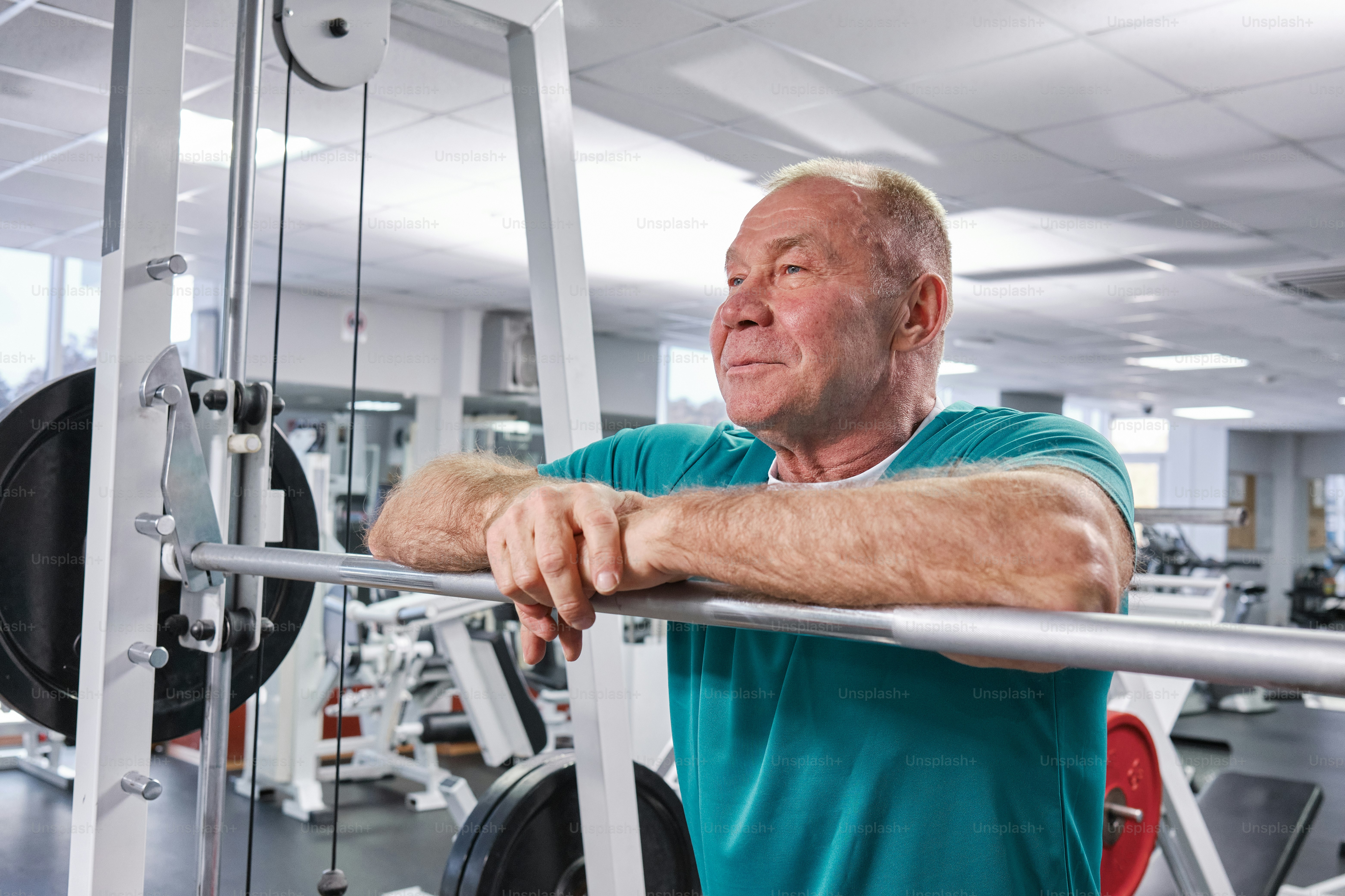 a man in a gym with a bar in front of him