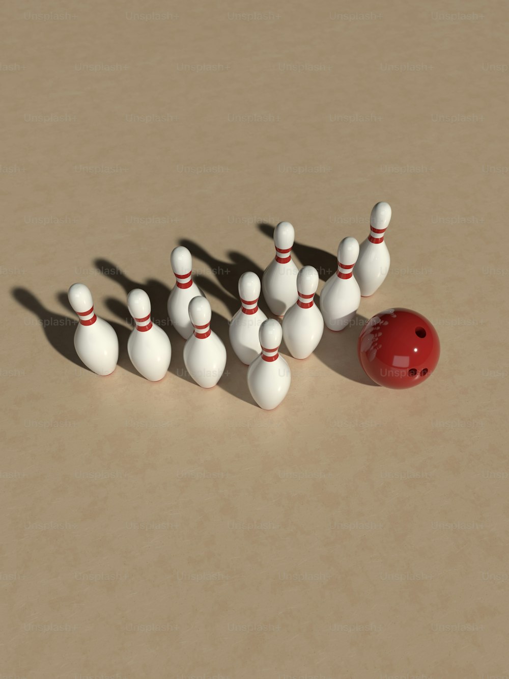un groupe de quilles de bowling et une boule rouge