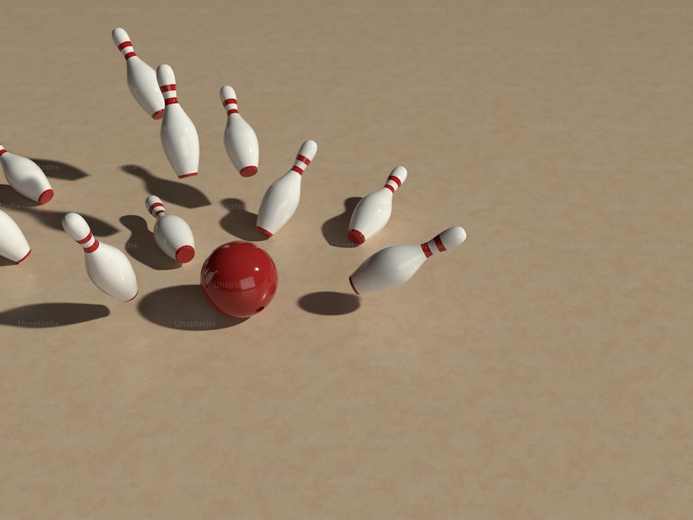 eine Gruppe weißer und roter Bowling-Pins und eine rote Kugel