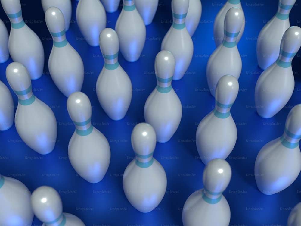 a group of white bowling pins with blue pins