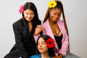 a woman is cutting another woman's hair with a flower in her hair