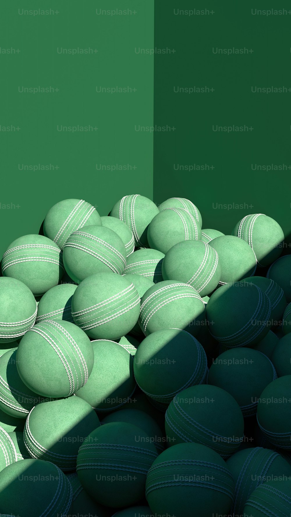 a pile of green and white balls in a room