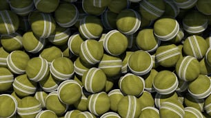 a large pile of tennis balls stacked on top of each other
