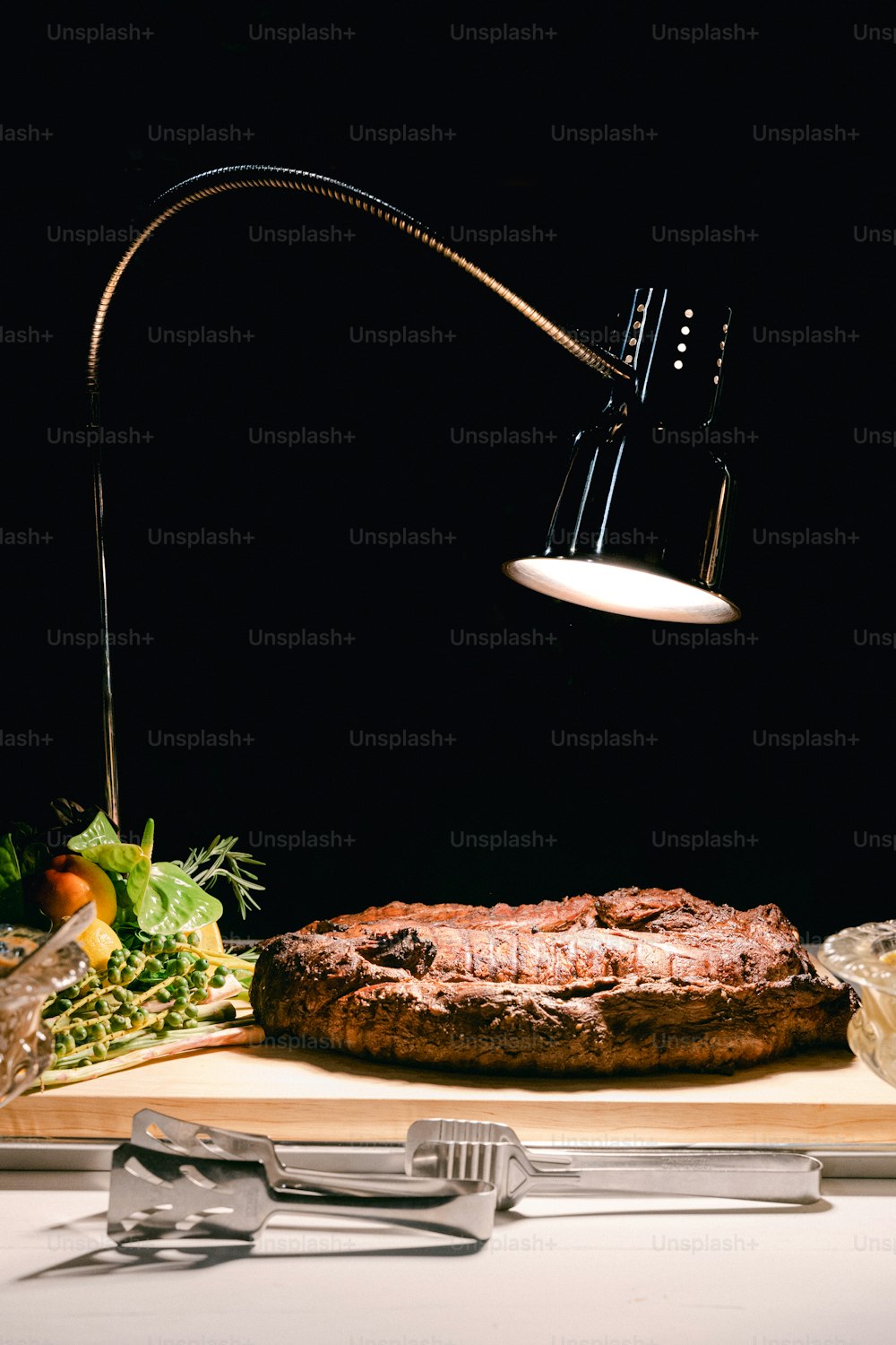 a table topped with a pizza under a lamp