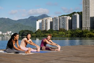 a group of women sitting on top of yoga mats