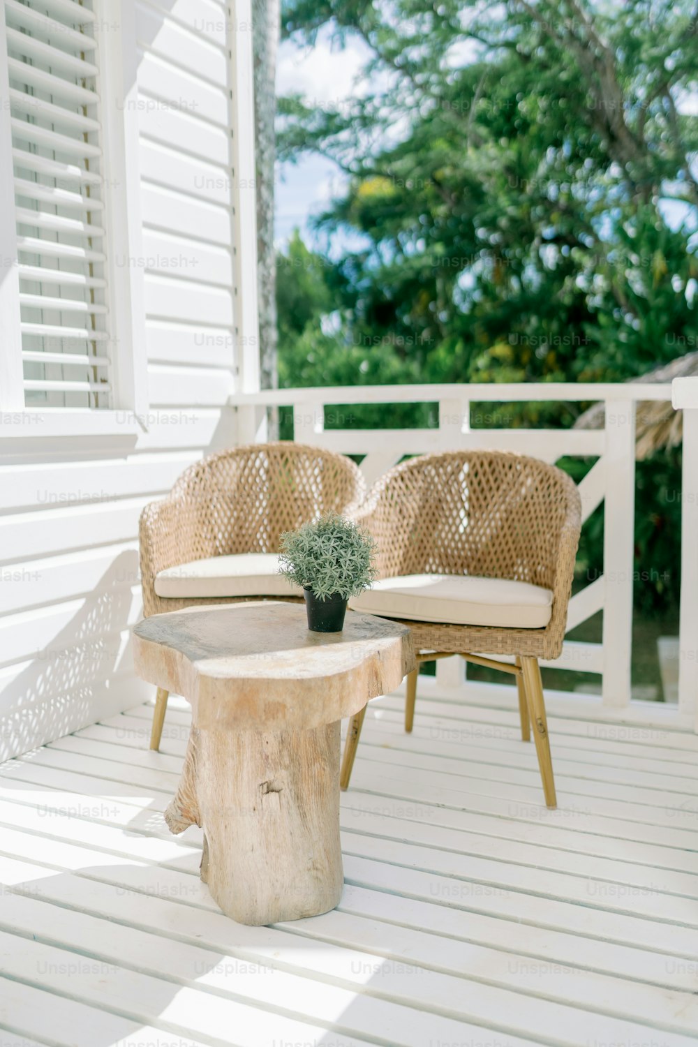 two chairs and a table on a porch