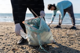 Dos personas recogiendo basura en la playa