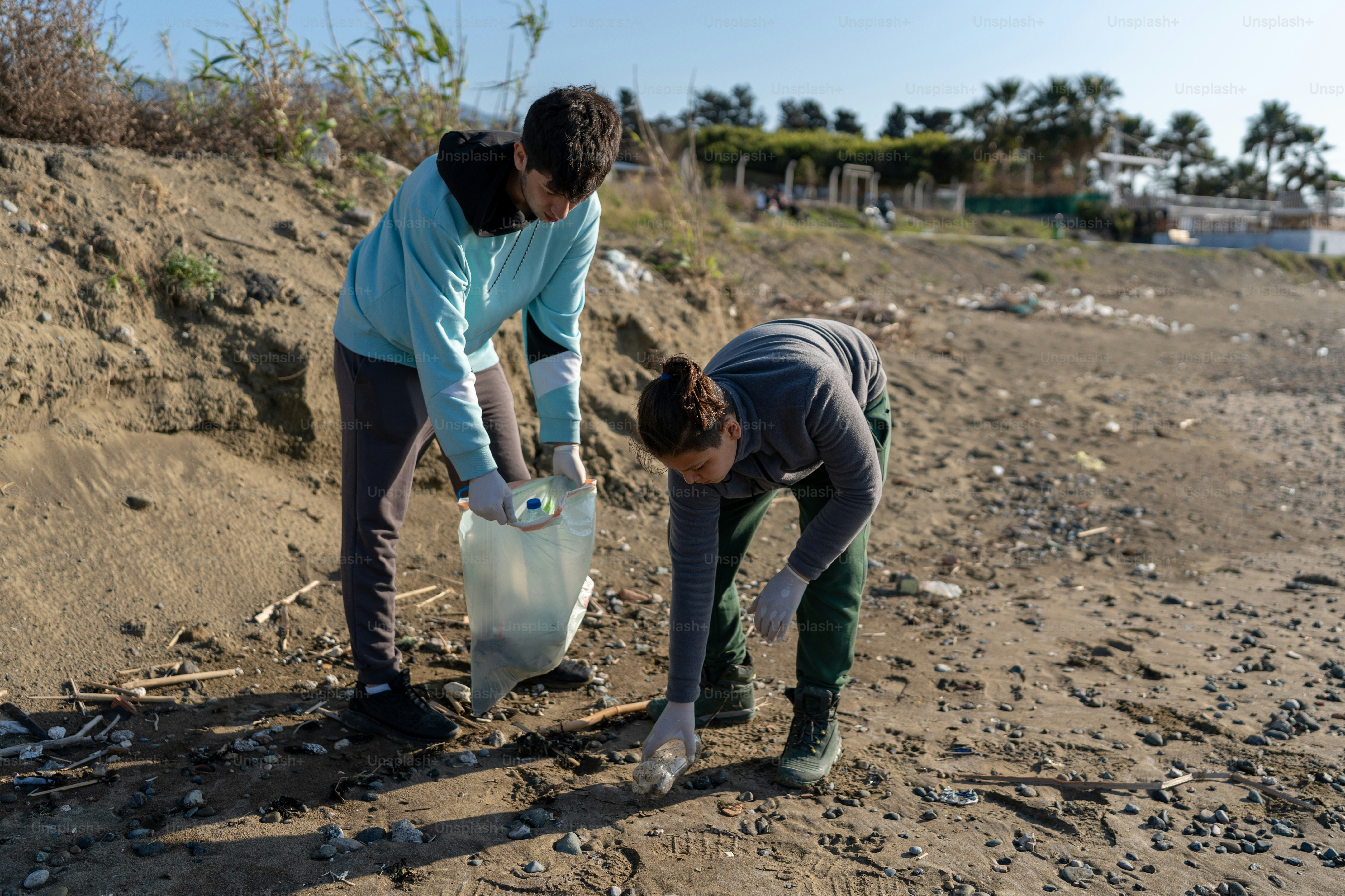 A couple of people that are standing in the dirt photo Litter pick