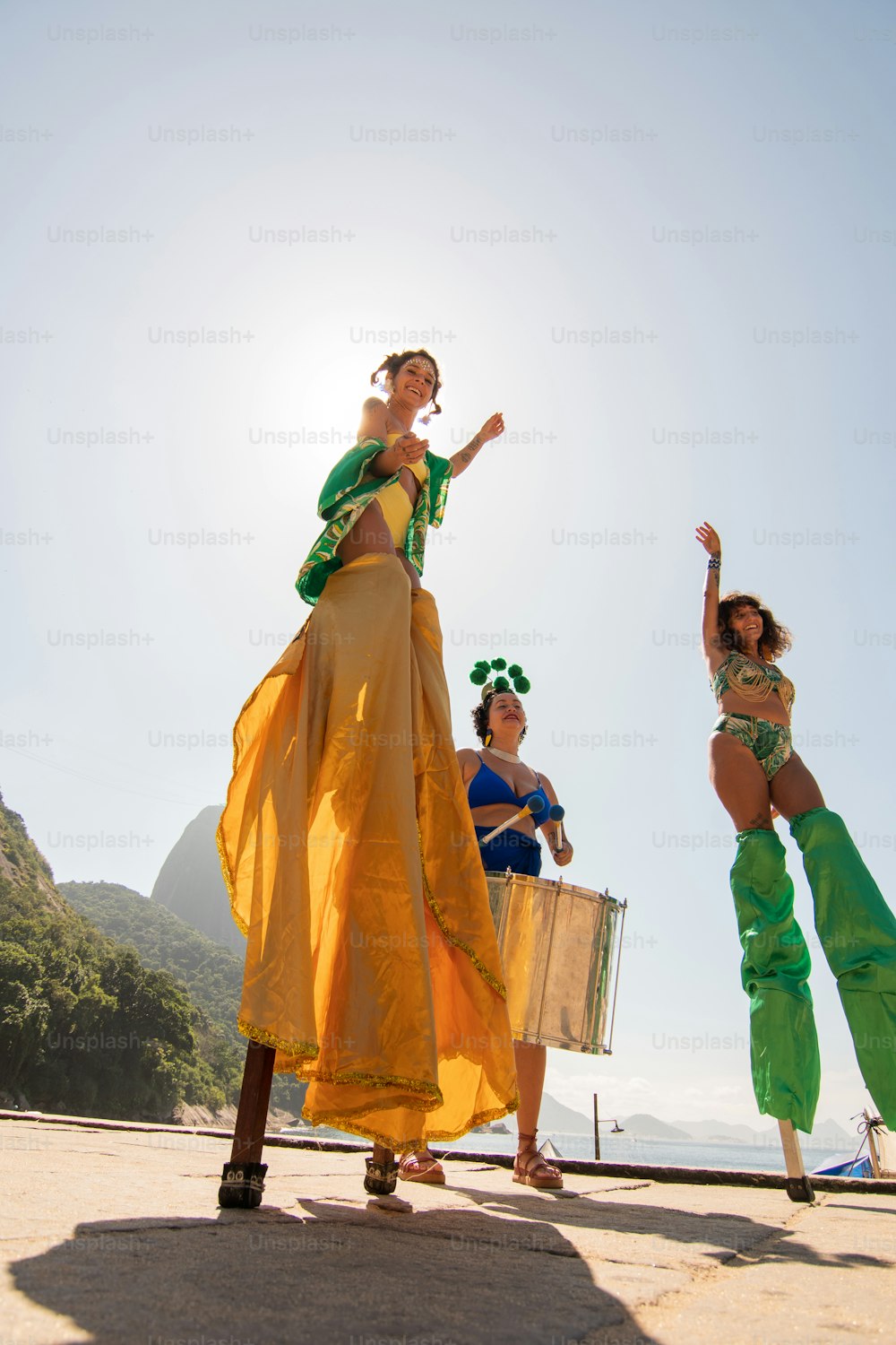 a group of women standing on top of a sandy beach