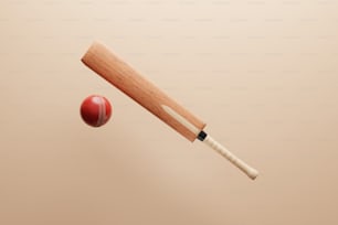 Un bate de cricket de madera golpeando una pelota roja