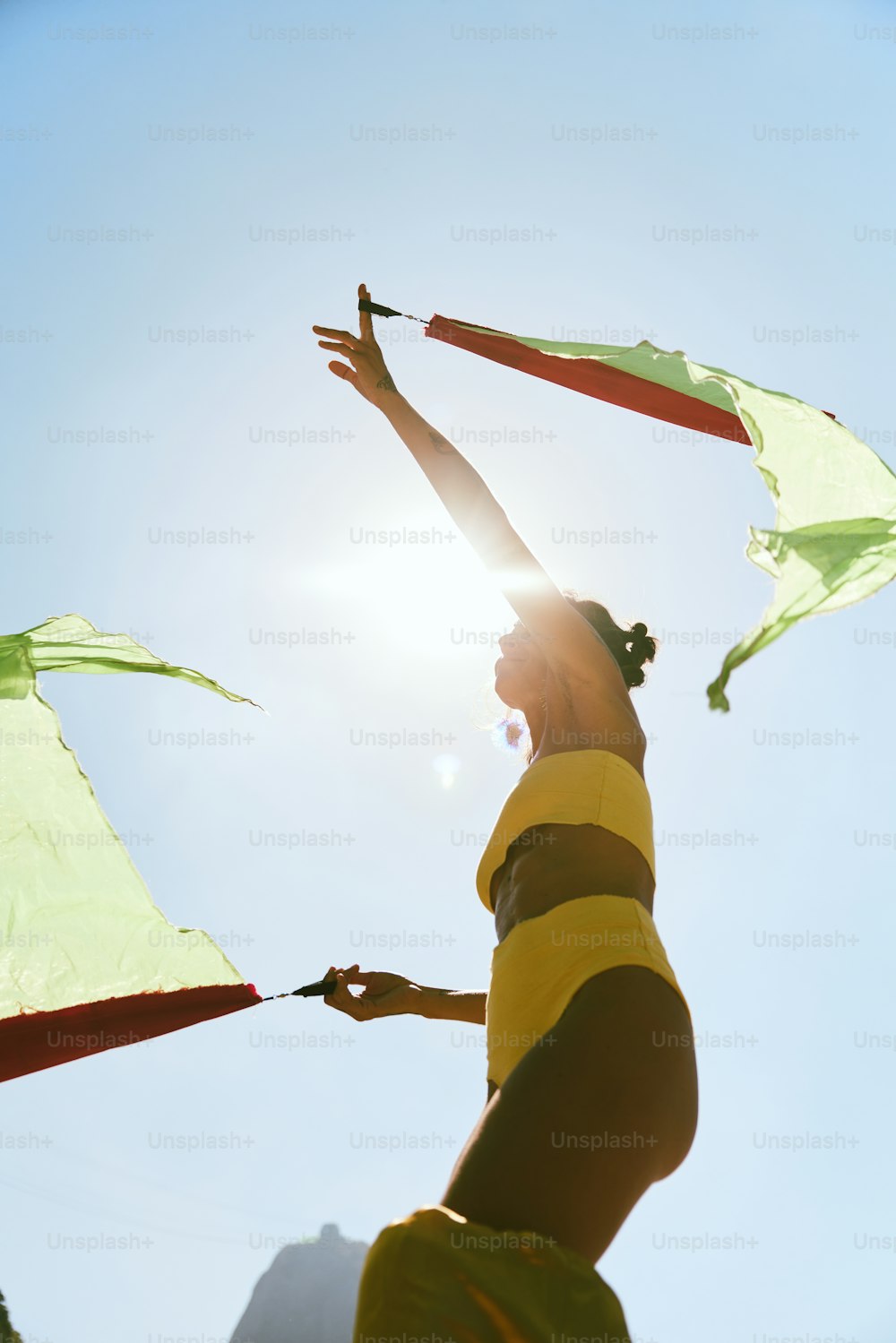 a woman holding a kite in the air