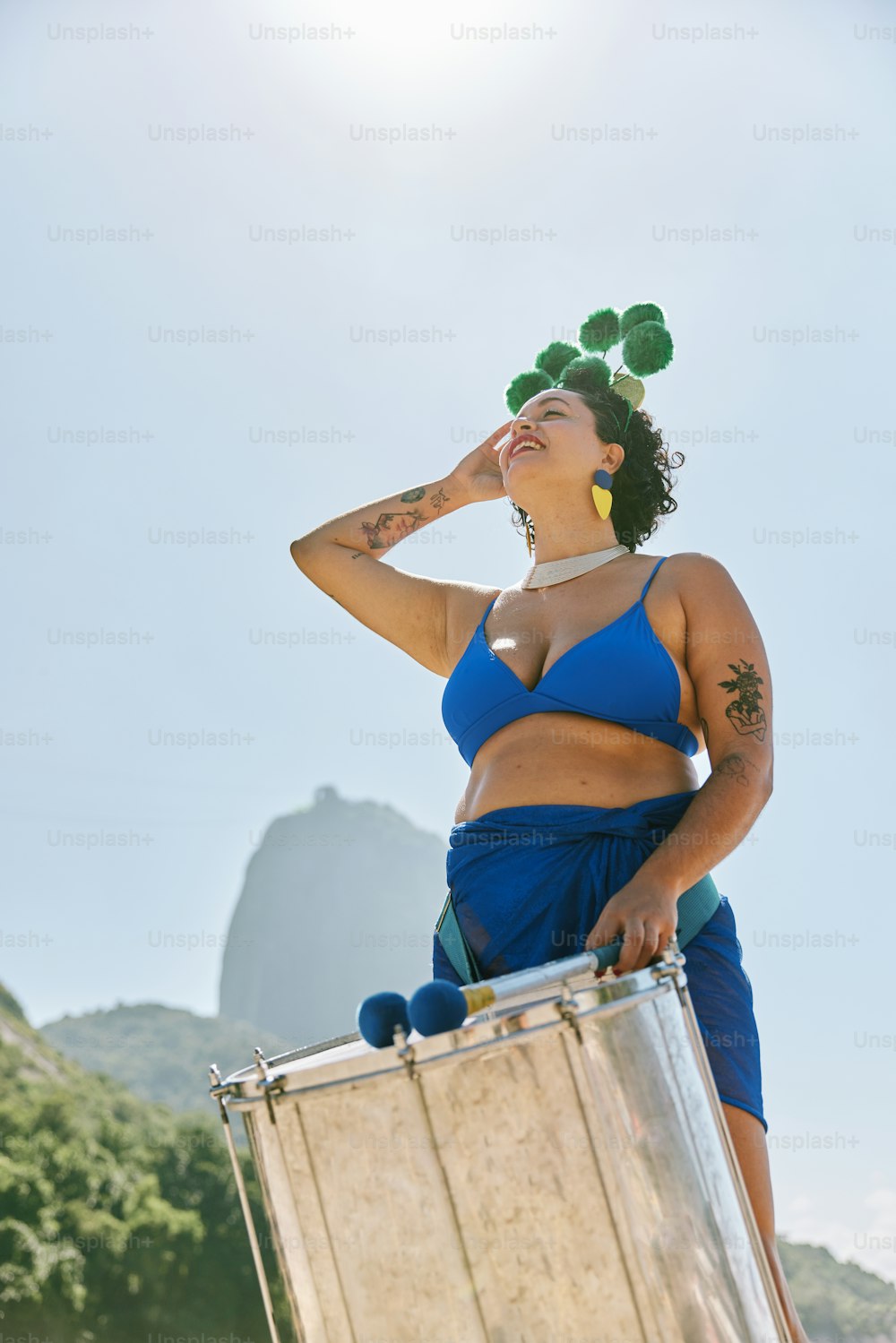 a woman in a blue bikini holding a suitcase