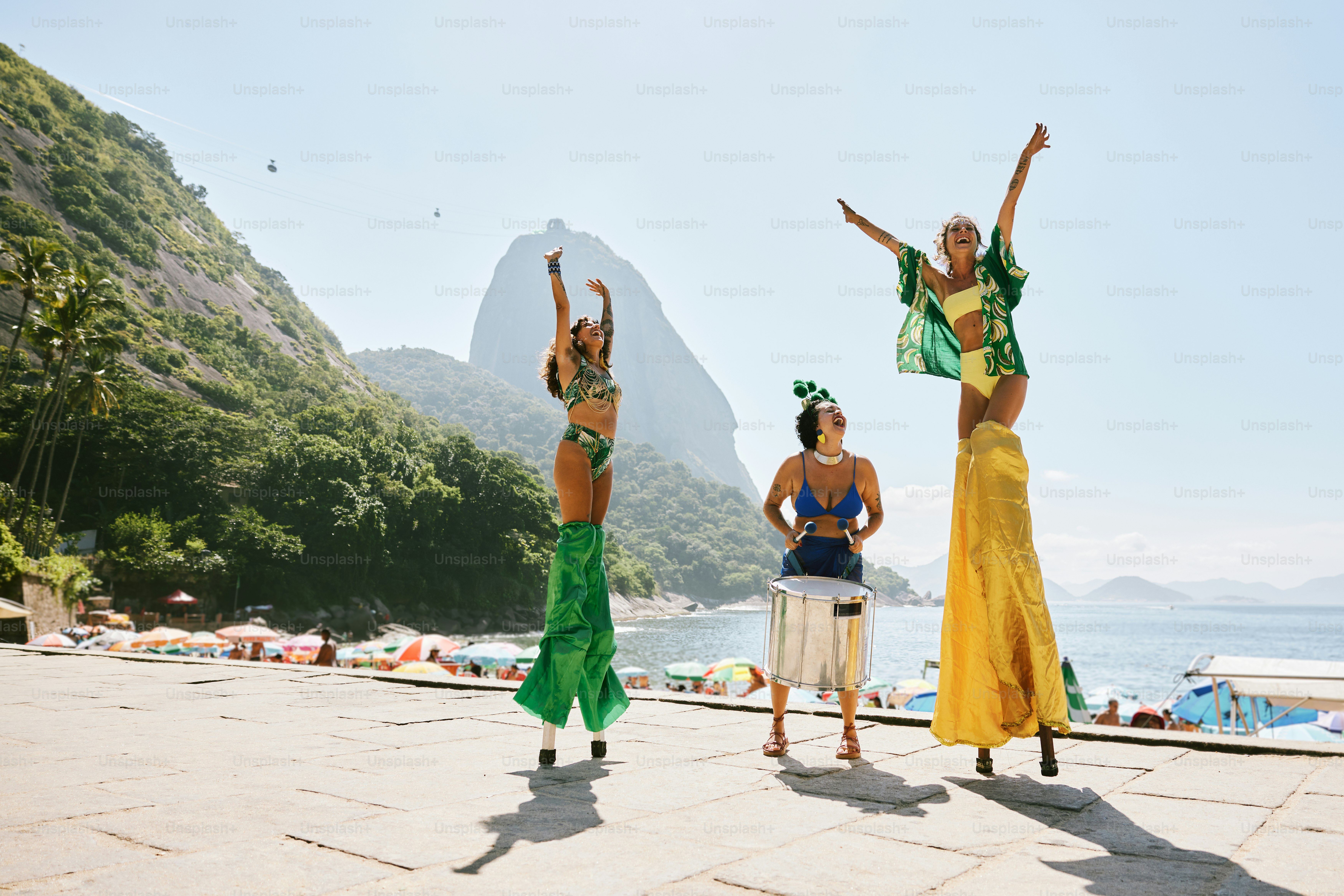 a group of women standing next to each other on a beach