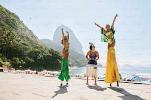 a group of women standing next to each other on a beach