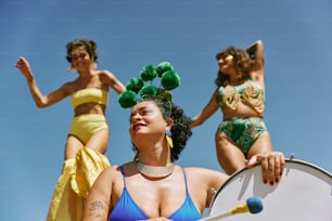 a group of women in bikinis standing next to each other