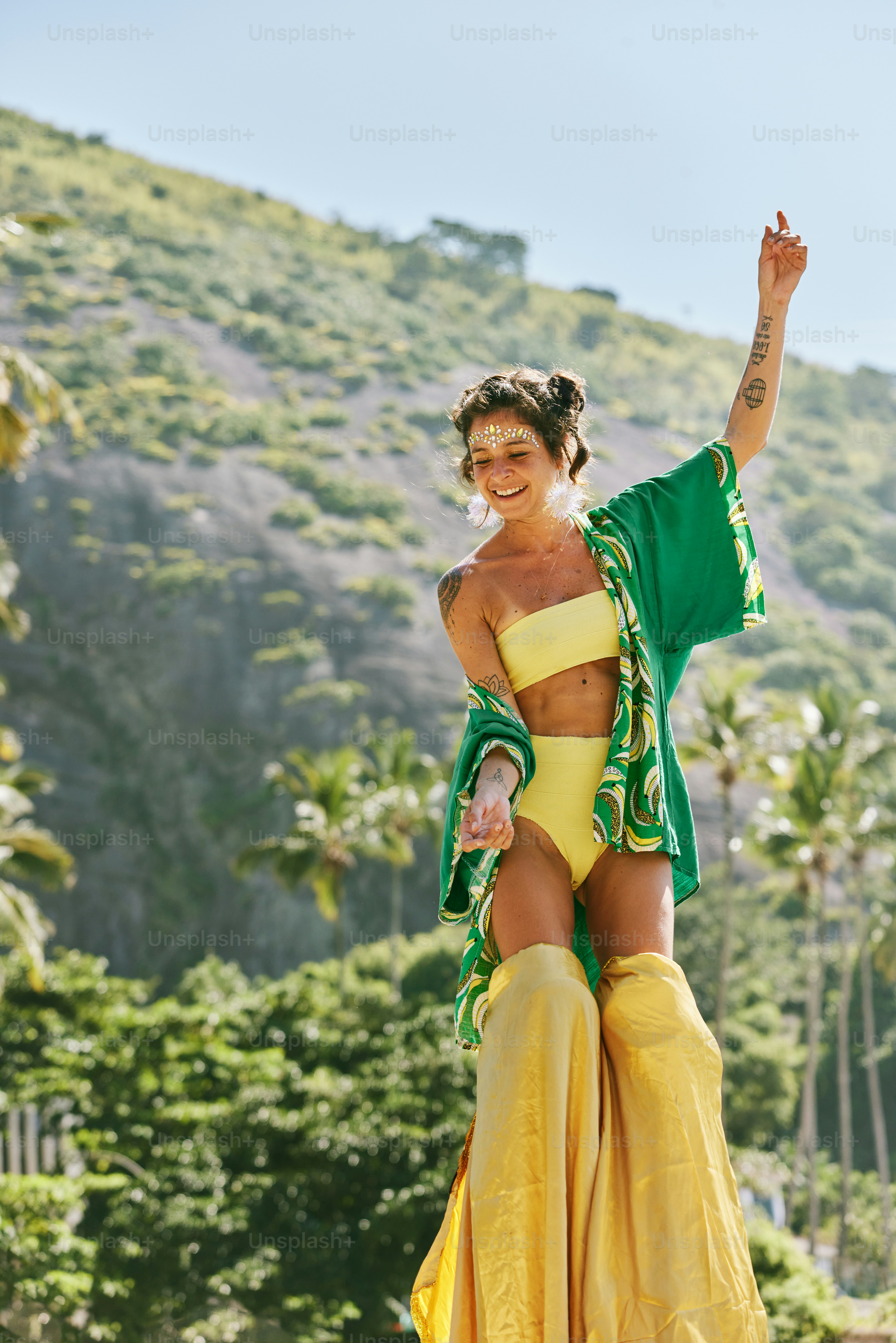 a woman in a yellow bikini top and yellow skirt