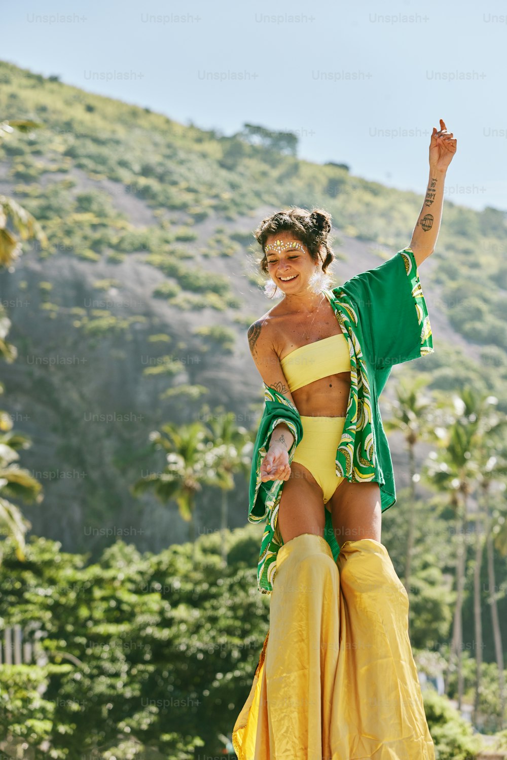 a woman in a yellow bikini top and yellow skirt