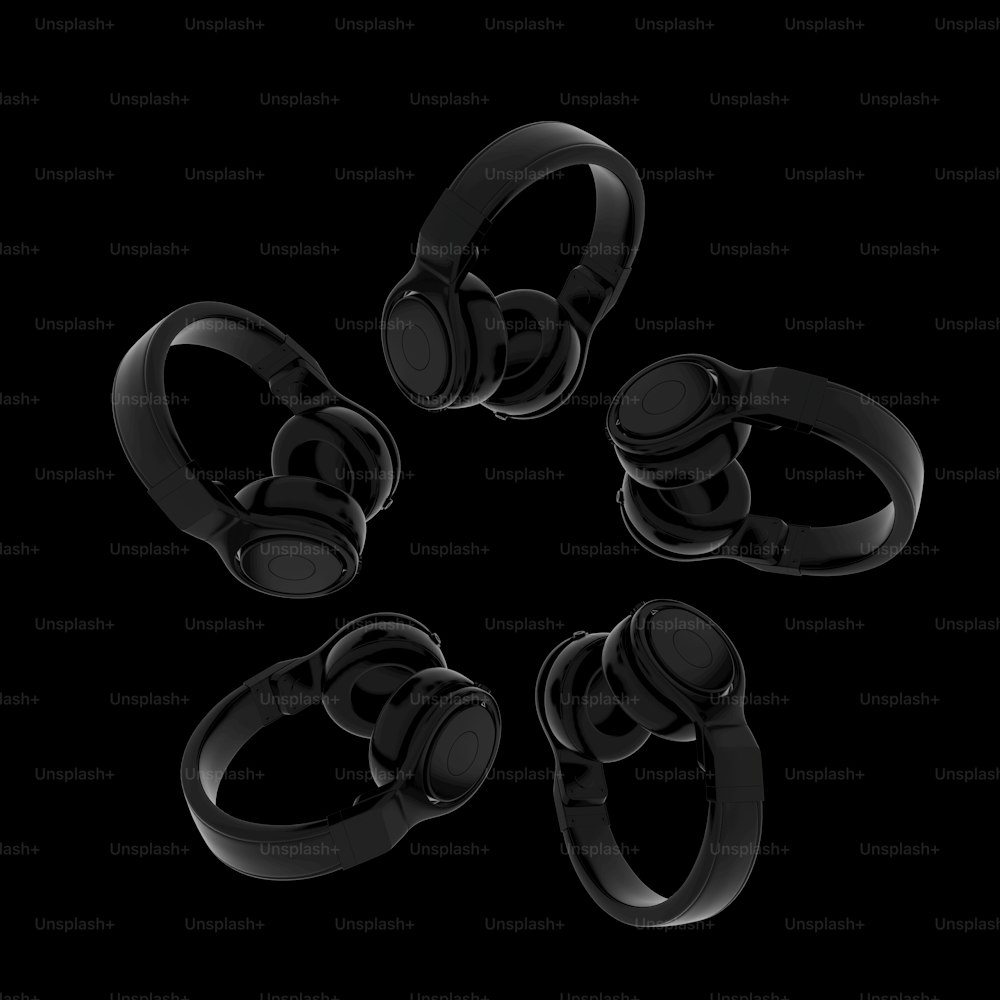 a group of black headphones sitting on top of each other