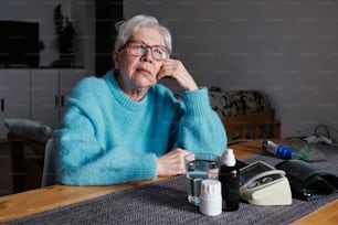 a woman sitting at a table with a glass of water