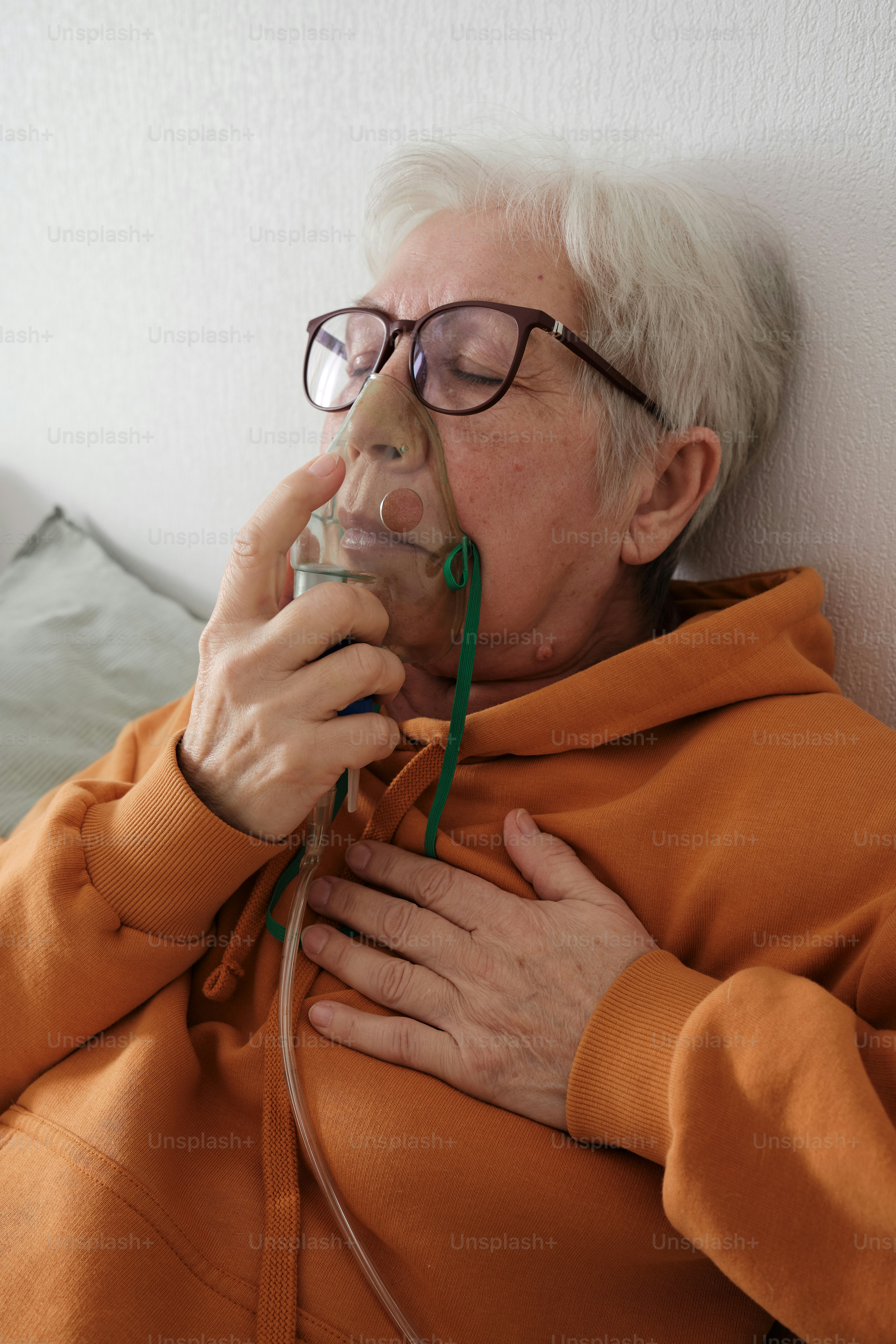 an older woman with glasses is laying down