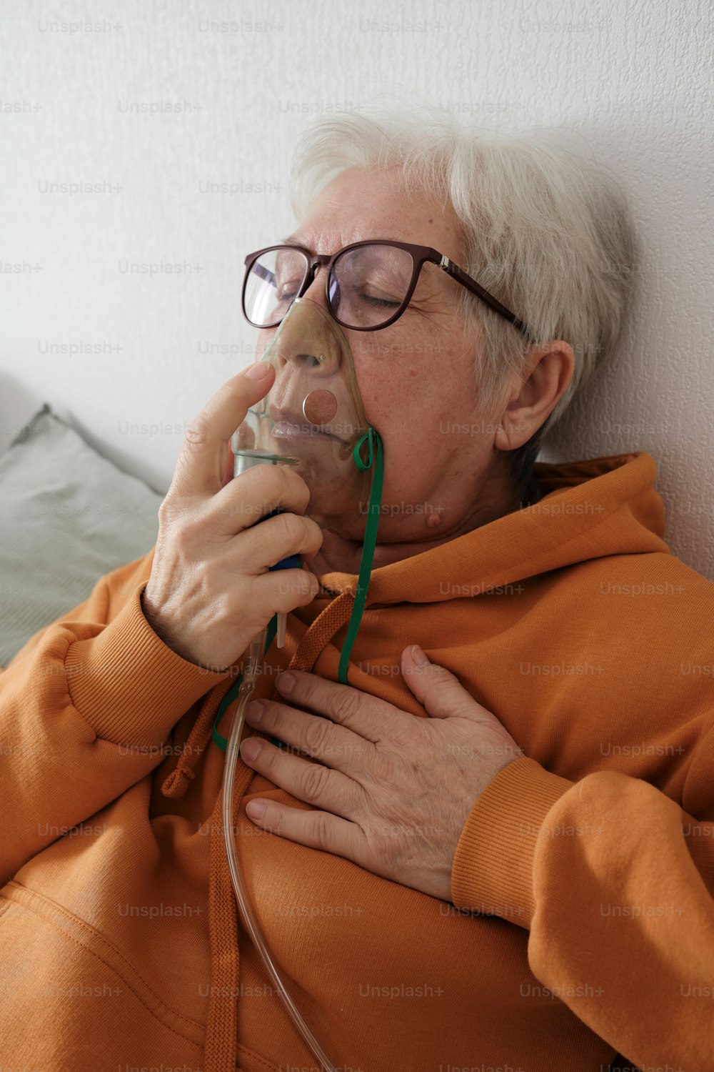 an older woman with glasses is laying down