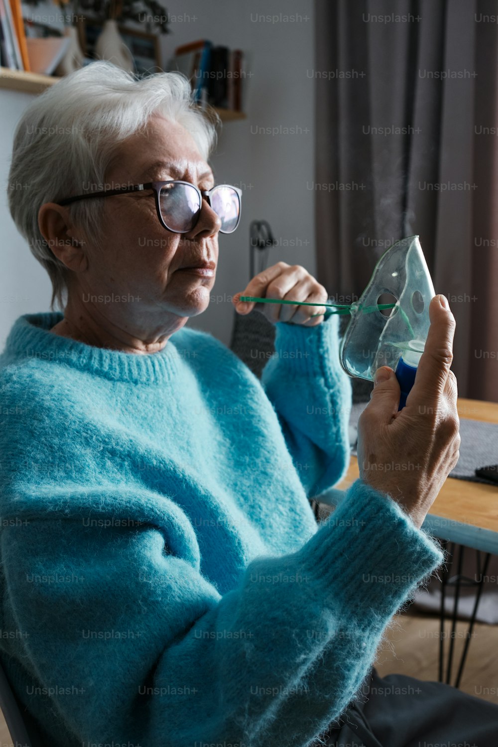 a woman in a blue sweater is holding a glass