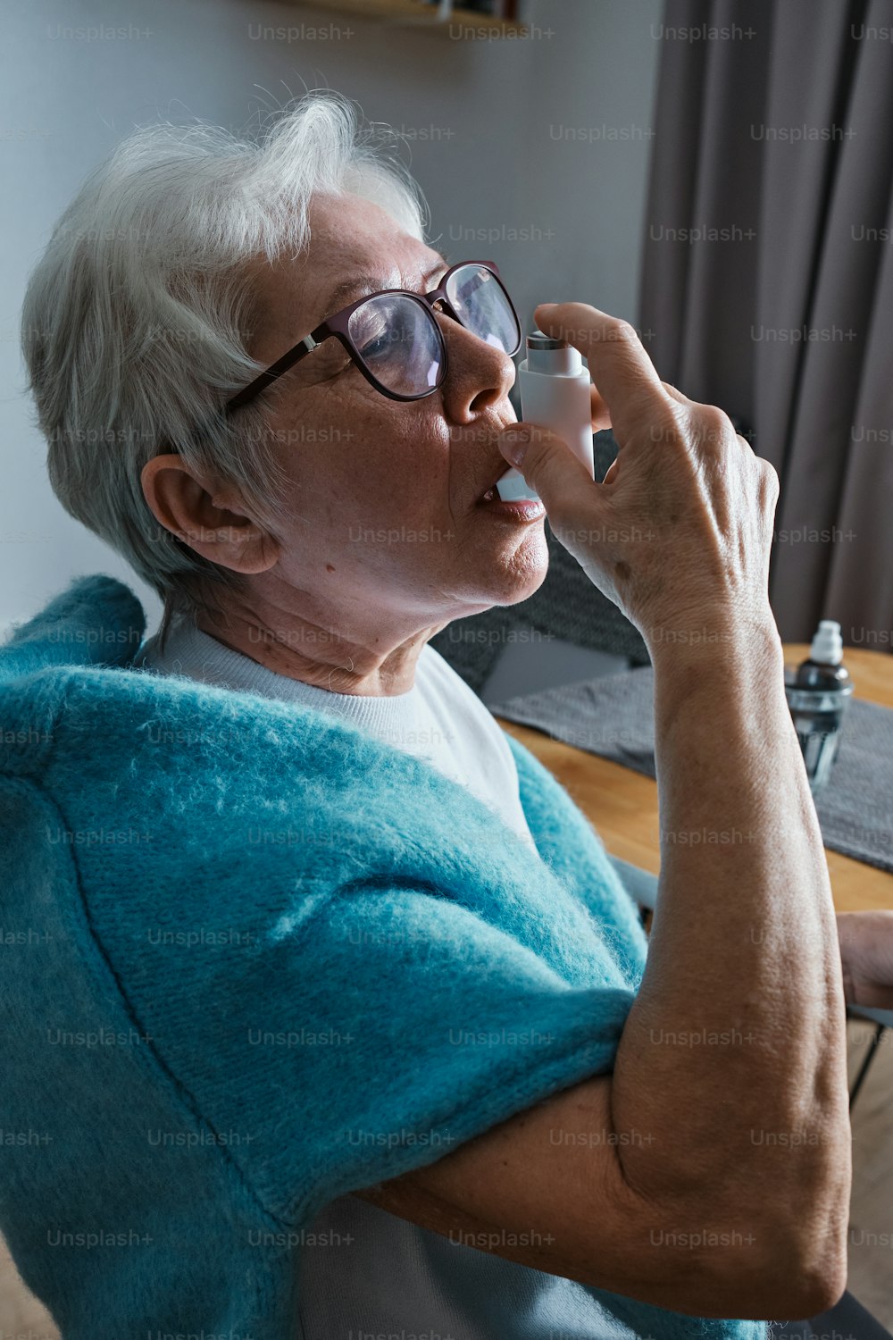 a woman with glasses and a blue towel on her shoulder