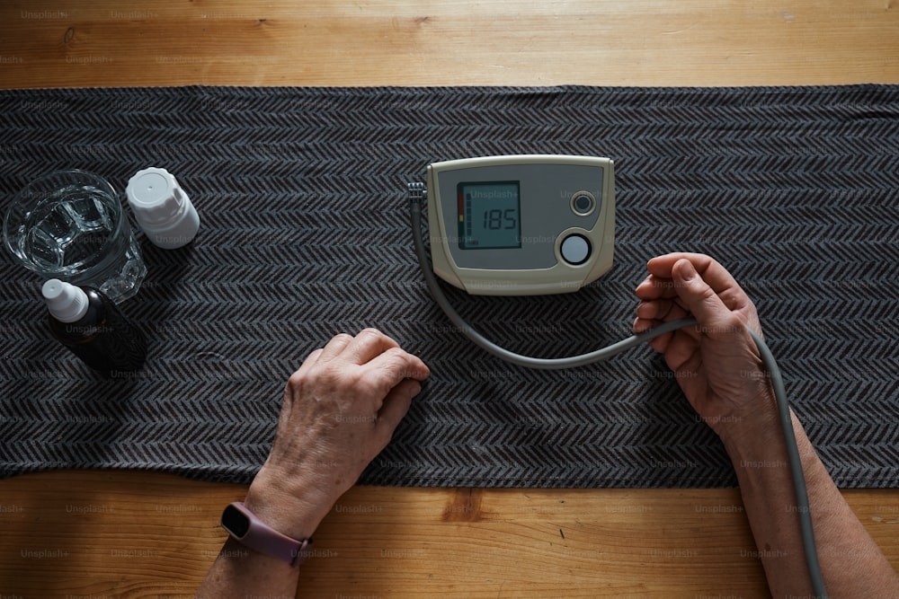 a person using a blood pressure meter on a table