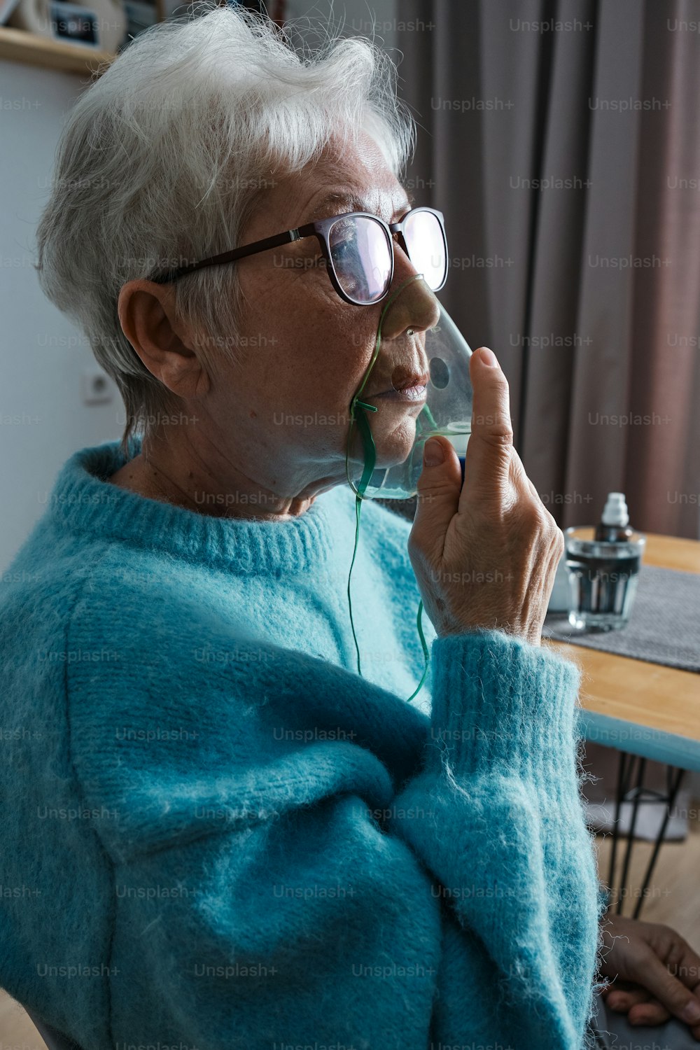 a woman in a blue sweater talking on a cell phone