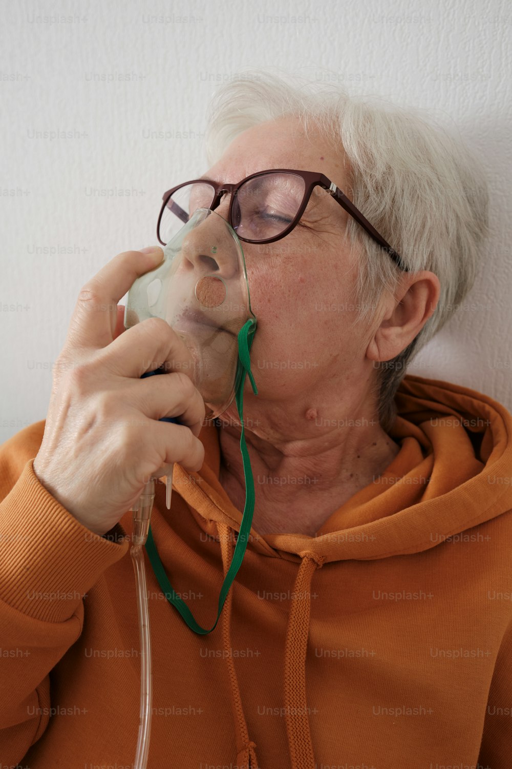 an older woman wearing glasses talking on a cell phone