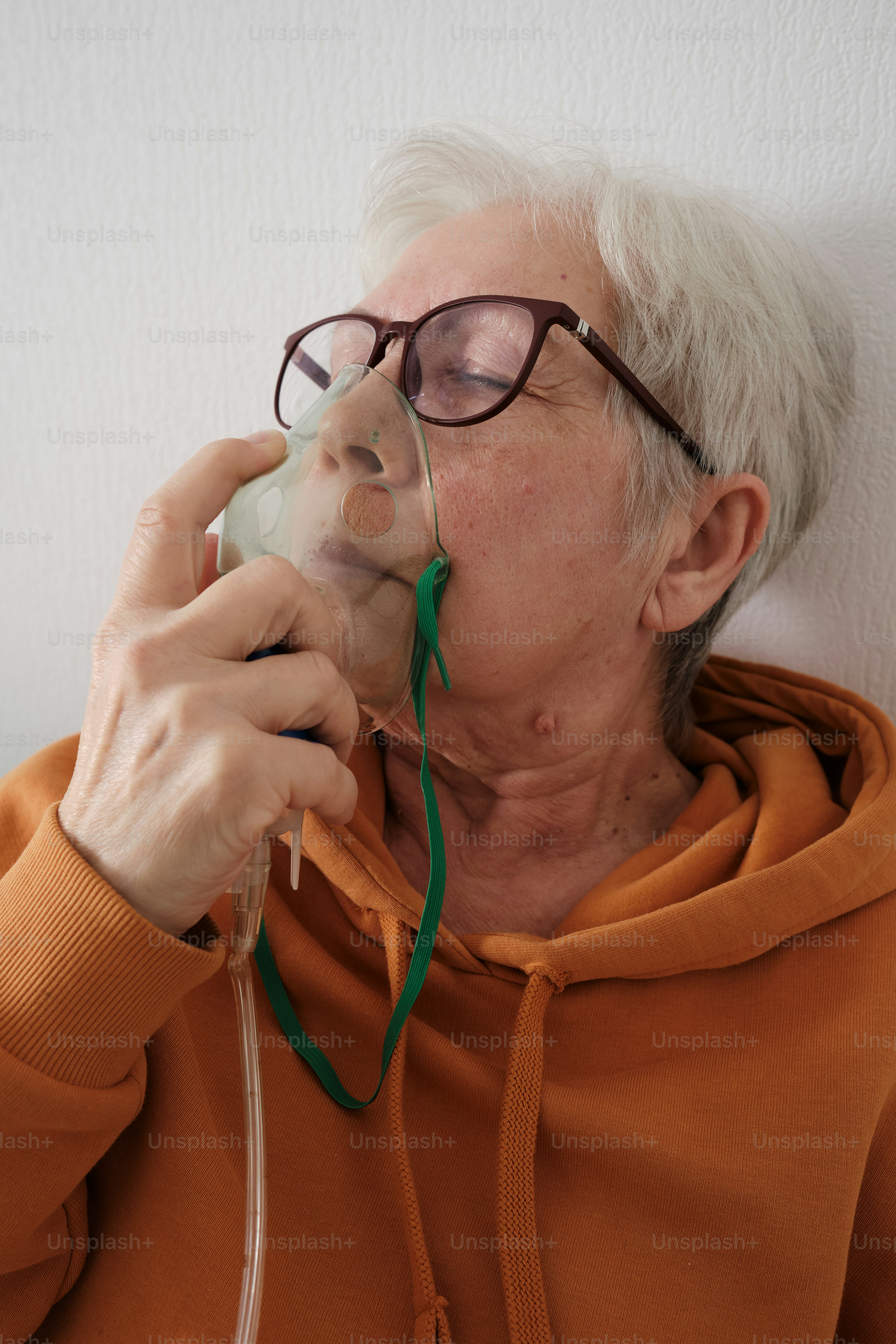 Closeup of a woman with an oxygen mask at home