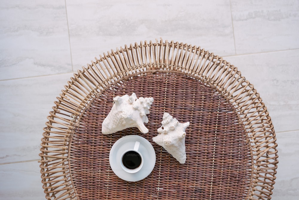 a wicker table topped with a cup of coffee