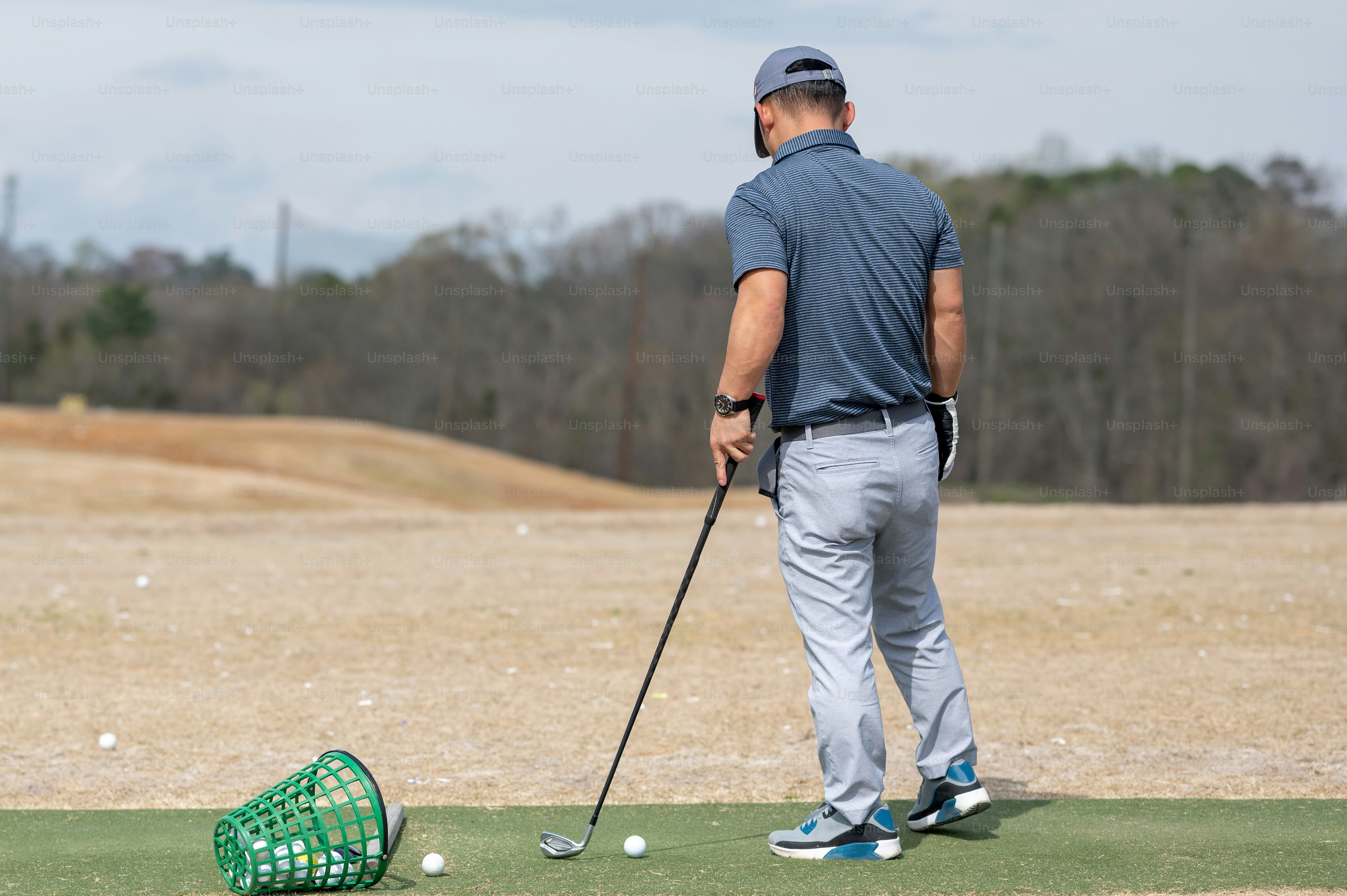 ゴルフ場でゴルフをする男性