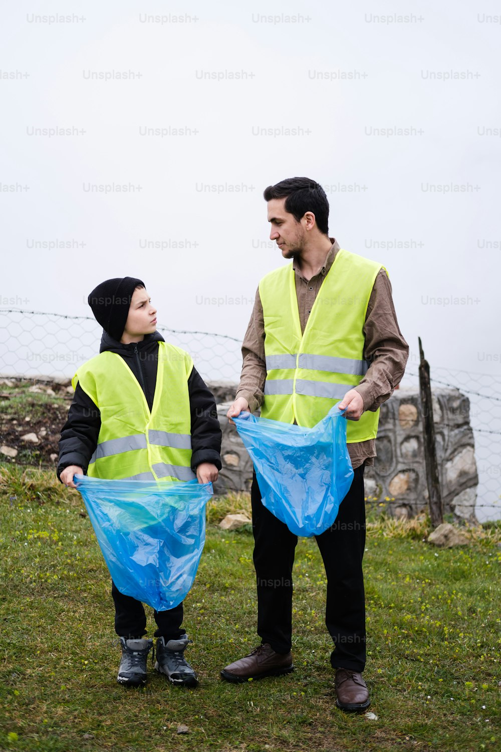 a man and a woman wearing safety vests