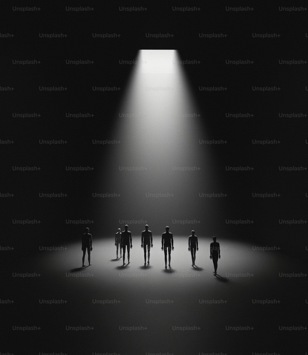 a group of people standing in front of a light