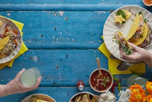 a table topped with plates of food and drinks