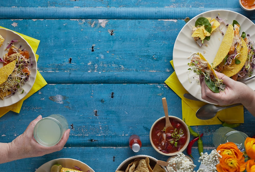 a table topped with plates of food and drinks