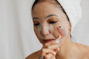 a woman with a towel on her head and a face mask on